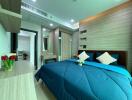 Modern bedroom with blue bedding and wooden furnishings