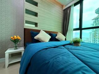 Modern bedroom with blue bedding and large window