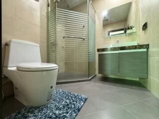 Modern bathroom with glass shower and floating vanity