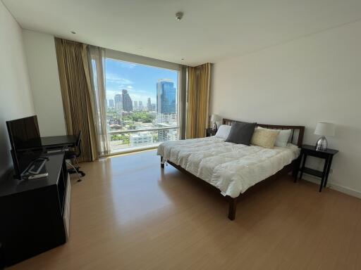 Spacious bedroom with a city view