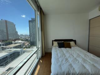 Bedroom with large window offering city view