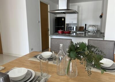 Modern kitchen and dining area with a table setting and appliances