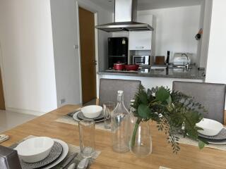 Modern kitchen and dining area with a table setting and appliances