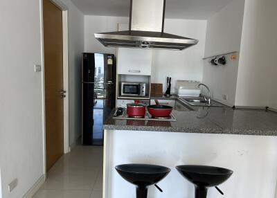 Modern kitchen with island, appliances, and bar stools