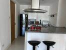 Modern kitchen with island, appliances, and bar stools