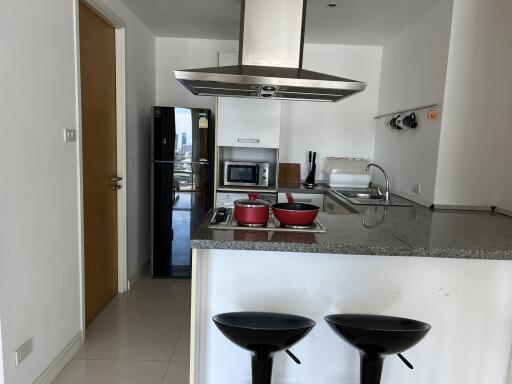 Modern kitchen with island, appliances, and bar stools