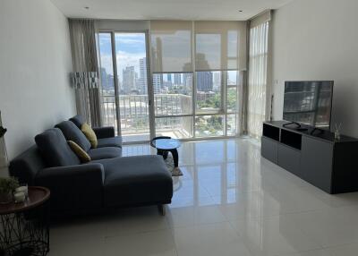 Living room with large windows and cityscape view