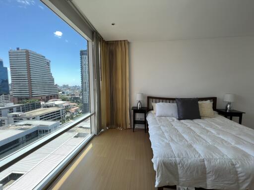 Bright bedroom with large window and city view