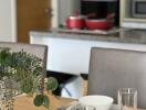 Dining table with bowls and glasses, kitchen in the background