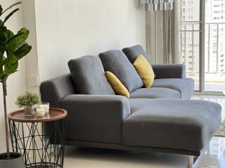 cozy living room with modern grey sofa and yellow pillows