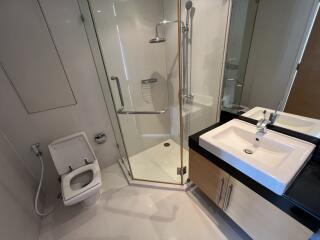 Modern bathroom with shower, sink, and bidet