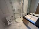 Modern bathroom with shower, sink, and bidet