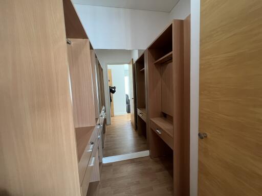 Spacious walk-in closet with wooden shelving and ample storage