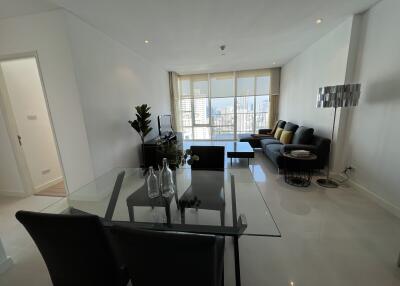 Spacious living room with a dining area and city view