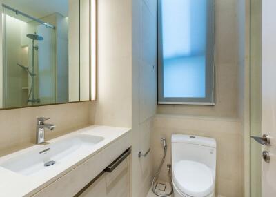 Modern bathroom with sink, toilet, and shower area