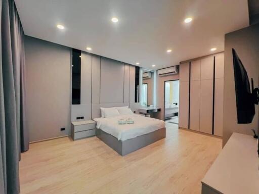 modern bedroom with double bed, nightstands, and large windows