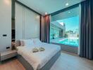 Modern bedroom with large window overlooking pool