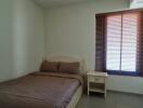 Bedroom with bed and window with blinds