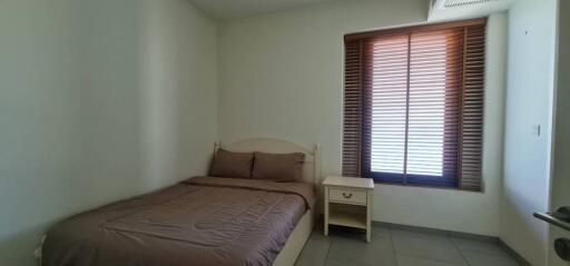 Bedroom with bed and window with blinds