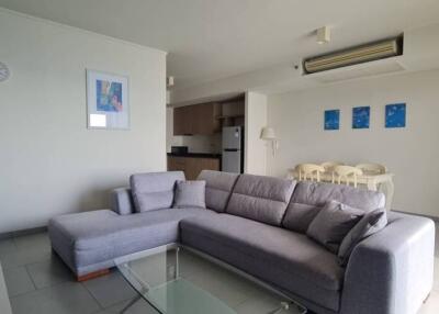 modern living room with gray sectional sofa and dining area