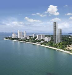 Aerial view of a coastal city with high-rise buildings and greenery