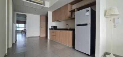 Modern kitchen area with wooden cabinetry and sleek appliances