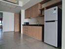 Modern kitchen area with wooden cabinetry and sleek appliances