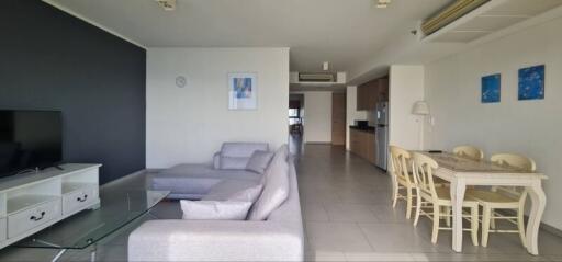 Spacious living area with modern furniture and integrated dining space