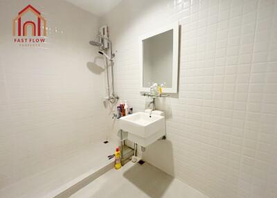 Modern bathroom with sink, mirror, and shower