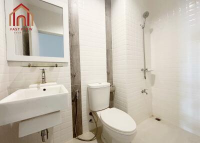 Simple white bathroom with shower and toilet