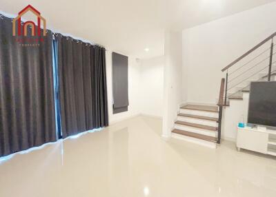 Modern living room with staircase and television