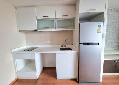 Modern kitchen with white cabinetry and stainless steel appliances