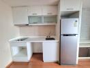 Modern kitchen with white cabinetry and stainless steel appliances