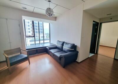 Modern living room with large window and comfortable seating