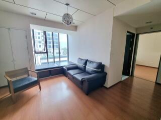 Modern living room with large window and comfortable seating