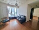 Modern living room with large window and comfortable seating