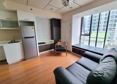 Modern living room with kitchen area and large windows