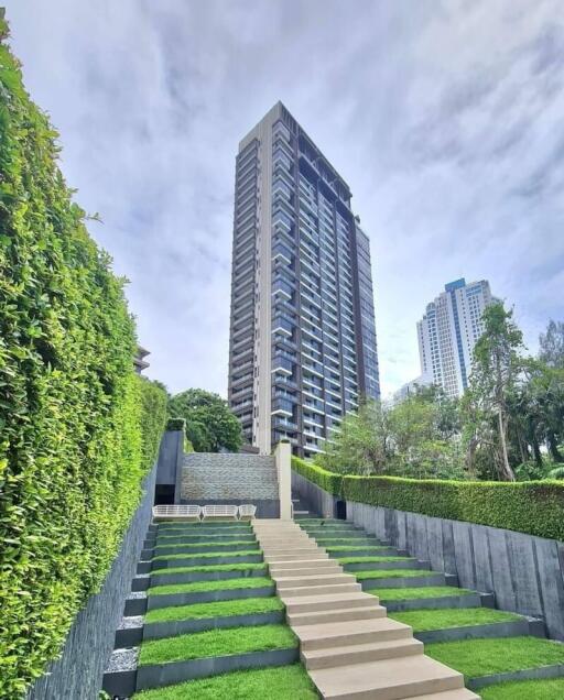 Modern high-rise building with landscaped garden