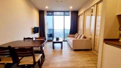 Living room with dining area and large window