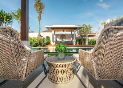 outdoor seating area with a view of the pool and garden