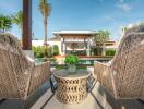 outdoor seating area with a view of the pool and garden