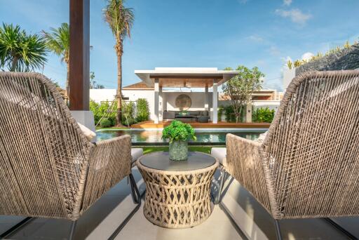 outdoor seating area with a view of the pool and garden