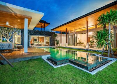 Modern villa with a pool at dusk