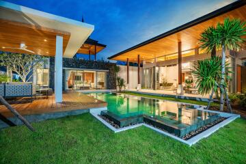 Modern villa with a pool at dusk