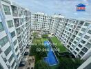 View of residential buildings with a swimming pool and green space