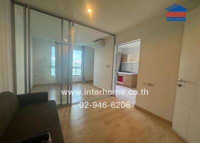 Living room with view into the kitchen