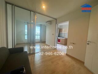 Living room with view into the kitchen