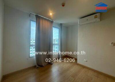 Bedroom with wooden floor, window, and air conditioning