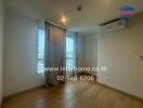 Bedroom with wooden floor, window, and air conditioning