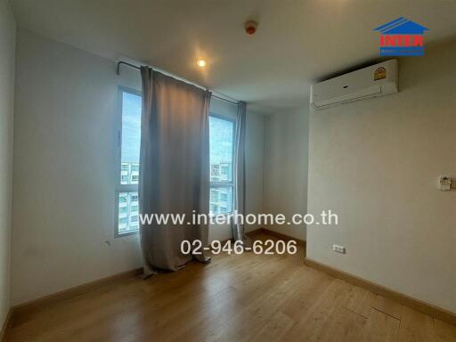 Bedroom with wooden floor, window, and air conditioning